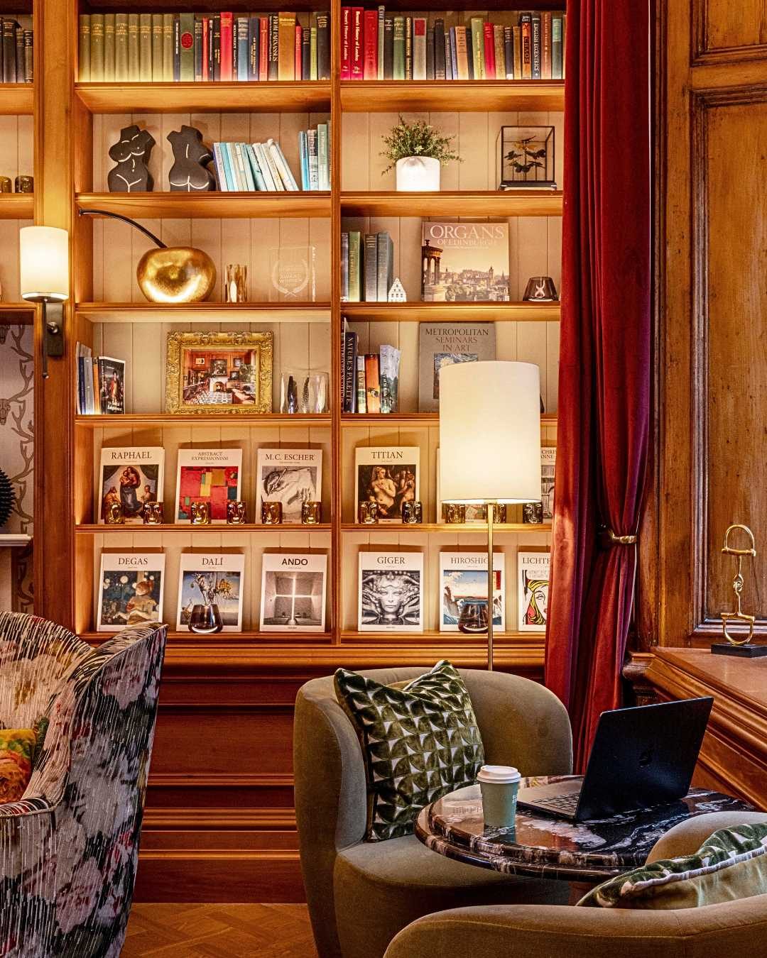 Hotel library lounge lined with bookshelves